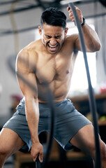 Fitness, battle ropes or strong man training for body goals in painful workout or exercise at a...