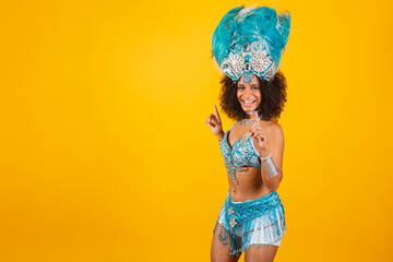 black woman queen of Brazilian samba school, with blue carnival clothes and crown of feathers. dancing.