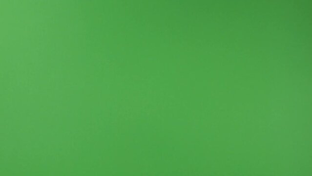 Falling Canadian 100 dollar polymer banknotes with a portrait of Robert Borden on a green background. Slow motion.