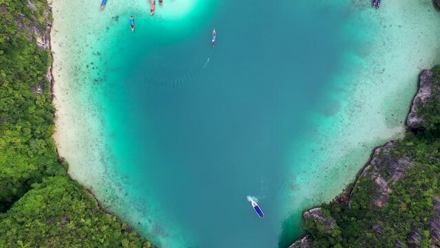 Aerial drone photo of iconic tropical turquoise water Pileh Lagoon surrounded by limestone cliffs, Phi phi islands, Thailand