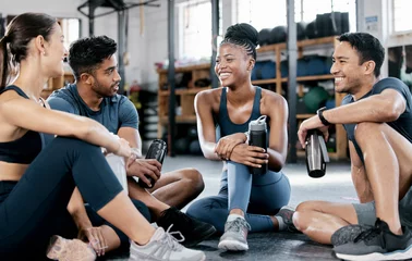 Fitness, conversation and friends at the gym for training, exercise motivation and relax after cardio. Laughing, happy and people with a group discussion about a workout, health class and performance