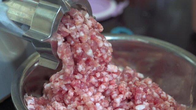 A Commercial Meat Grinder Machine In Operation, Churning Minced Meat