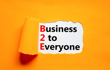 B2E business to everyone symbol. Concept words B2E business to everyone on white white paper on a beautiful orange background. Business and B2E business to everyone concept. Copy space.