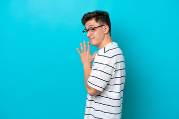 Young handsome Brazilian man isolated on blue background scheming something