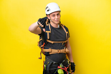 Young rock climber Brazilian man showing thumb down with negative expression