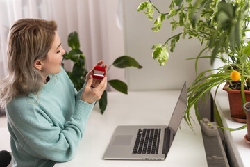 Online video call, marriage proposal to girlfriend. Laptop, computer. Engagement,wedding. red box.