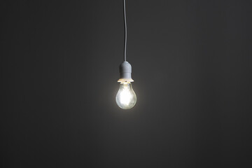 simple light bulb hanging near the wall at home