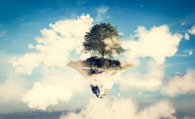 Floating island with green grass and tree on sky with clouds