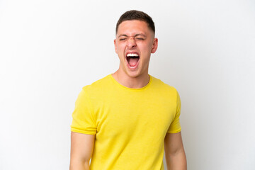 Young brazilian man isolated on white background shouting to the front with mouth wide open