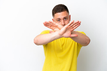 Young brazilian man isolated on white background making stop gesture with her hand to stop an act