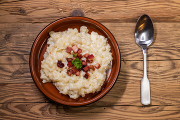 Slovakian halusky served with sheep cheese and roasted bacon