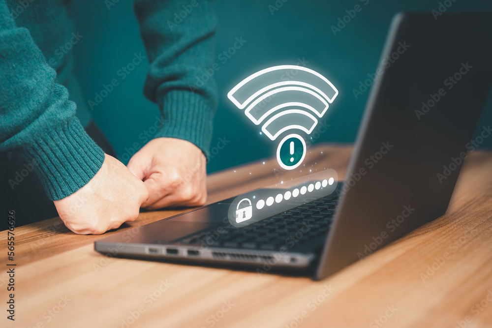 Poster Freelancer man using a laptop computer to connect to internet wifi and wait for digital information form website to load. Technology concept of waiting to connect to internet Wi-Fi.