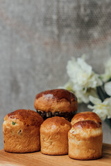 Delicious Easter cakes on a wooden table with flowers in the background. place for text. selective focus
