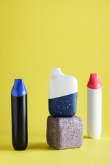 disposable electronic cigarettes or vapes on yellow background. copy space. nicotine vapor stick....