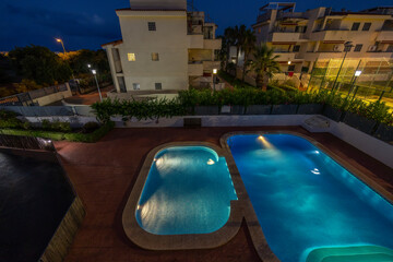 illuminated swimming pools at night
