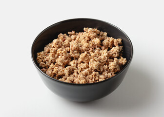 Granola in bowl on light background.