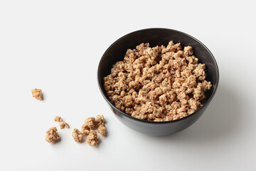 Granola in bowl on light background.