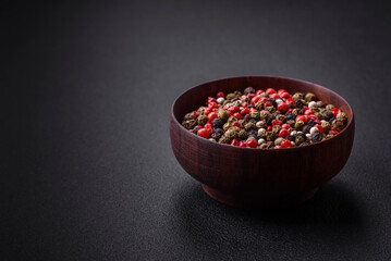 Spice allspice of different colors pink, white, green not ground in a wooden saucer