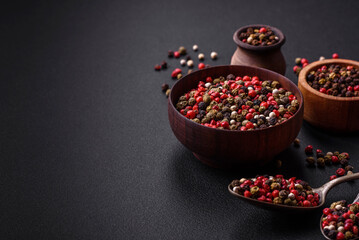 Spice allspice of different colors pink, white, green not ground in a wooden saucer
