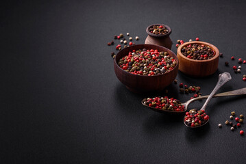Spice allspice of different colors pink, white, green not ground in a wooden saucer