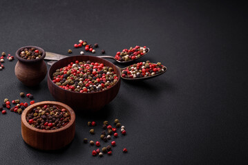 Spice allspice of different colors pink, white, green not ground in a wooden saucer