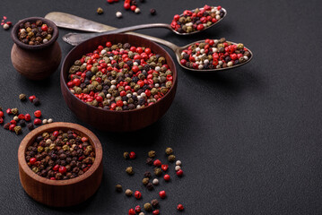 Spice allspice of different colors pink, white, green not ground in a wooden saucer