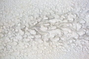 Texture of paint stains on the wall, cracked paint on an old metal surface. Sheet of silver metal with cracked and peeling paint, background for design with copy space.