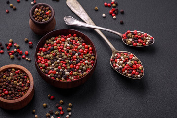 Spice allspice of different colors pink, white, green not ground in a wooden saucer