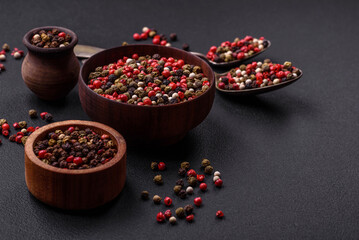 Spice allspice of different colors pink, white, green not ground in a wooden saucer