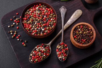 Spice allspice of different colors pink, white, green not ground in a wooden saucer