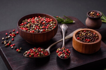 Spice allspice of different colors pink, white, green not ground in a wooden saucer
