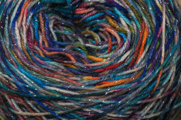 Closeup of colourful handspun and handdyed pure organic merino sheep woolyarn , spun on a spinning...