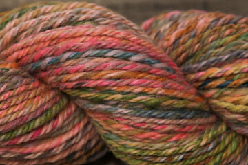 Closeup of colourful handspun and handdyed pure organic merino sheep wool yarn , spun on a spinning...