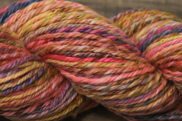 Closeup of colourful handspun and handdyed pure organic merino sheep wool yarn , spun on a spinning...