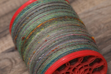 Closeup of colourful handspun and handdyed merino sheep wool, spun on a spinning wheel