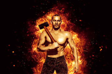 Obraz na płótnie Canvas Strong man with naked torso holds a sledgehammer while isolated on burning background. Copy Space 