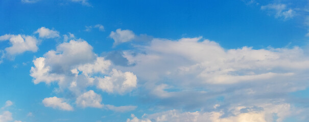 White clouds in the blue sky in sunny weather