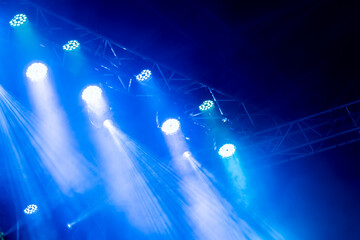 The dark stage shows, dark blue background, an empty dark scene, neon light, spotlights