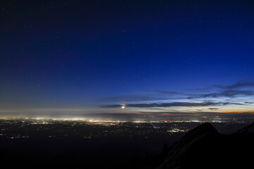 Aerial view of illuminated cityscape against sky during dusk