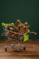shopping cart with moldy vegetable at vertical composition concept of lack of food