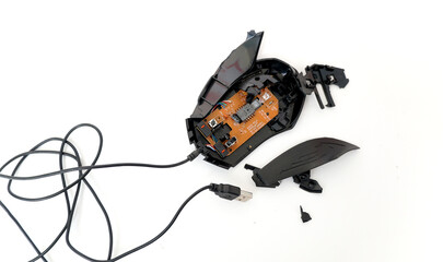 black out of order disassembled computer mouse on white background