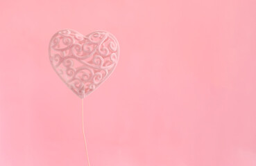 Postcard Valentine's Day, minimalism pink heart on a pink background.