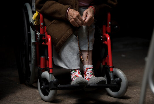 A woman prays the rosary in Our Lady of Guadalupe Home for the Elderly, Mexico City