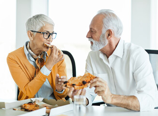 business meeting businesswoman woman office senior elderly businessman break pizza eating food man meal lunch friend friendship snack happiness fast italian hungry tasty teamwork