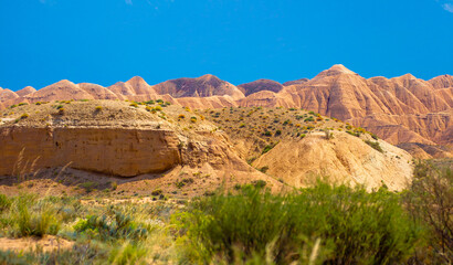 Natural unusual landscape of red rocks against the backdrop of blue mountains. The extraordinary beauty of nature is similar to the Martian landscape. Amazingly beautiful landscape.