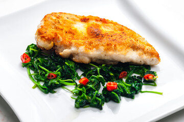 roasted duck breast served with salad of spinach leaves and chilli pepper