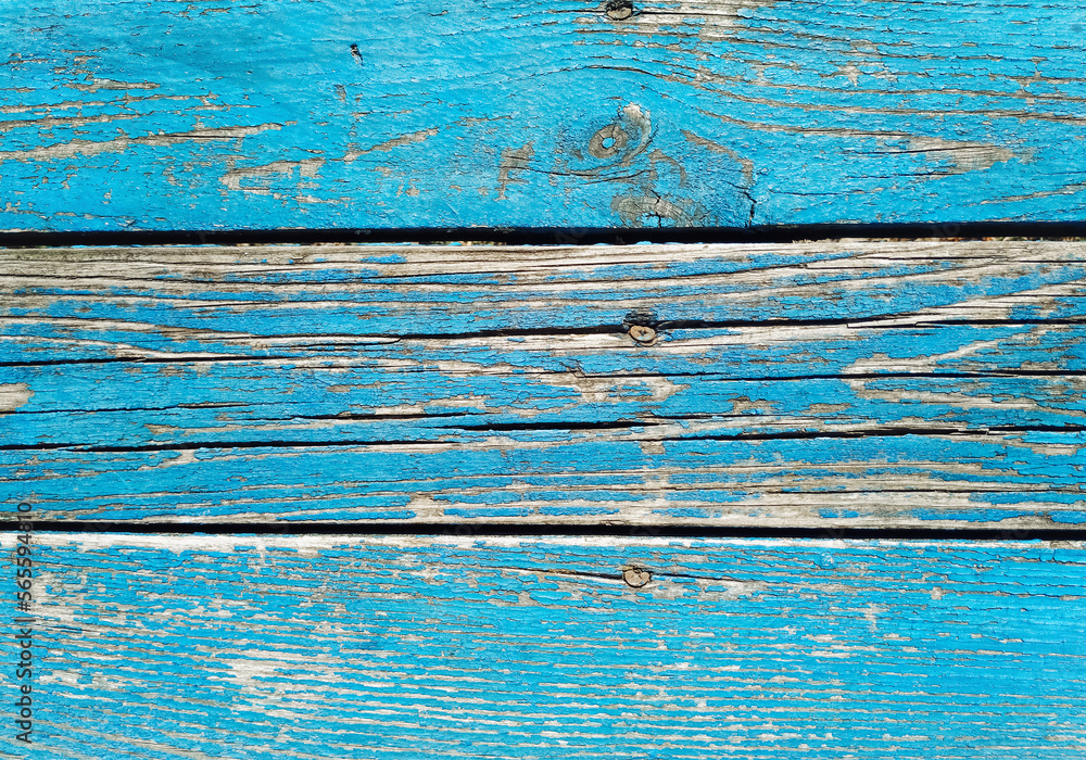 Wall mural Old blue cracked paint on top of a wooden table. Texture and grunge background.