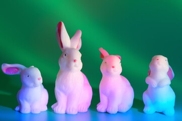 Toy white rabbits on a green background.