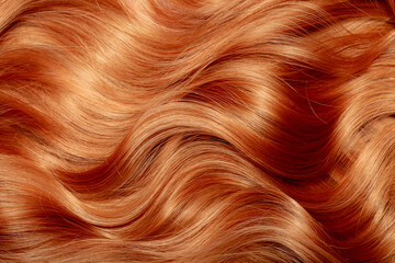 Red hair close-up as a background. Women's long orange hair. Beautifully styled wavy shiny curls. Hair coloring bright shades. Hairdressing procedures, extension. - Powered by Adobe