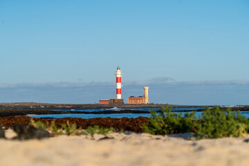 Fototapeta na wymiar Faro El Toston in El Cotillo. Beautiful background. Fuerteventura Lighthouse in Canary Island , Spain.